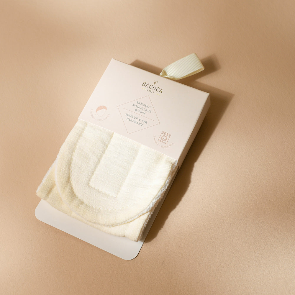 Bandeau de soin et maquillage Bachca présenté dans son étui, en coton doux, parfait pour retenir les cheveux pendant les soins du visage et l’application de maquillage.
