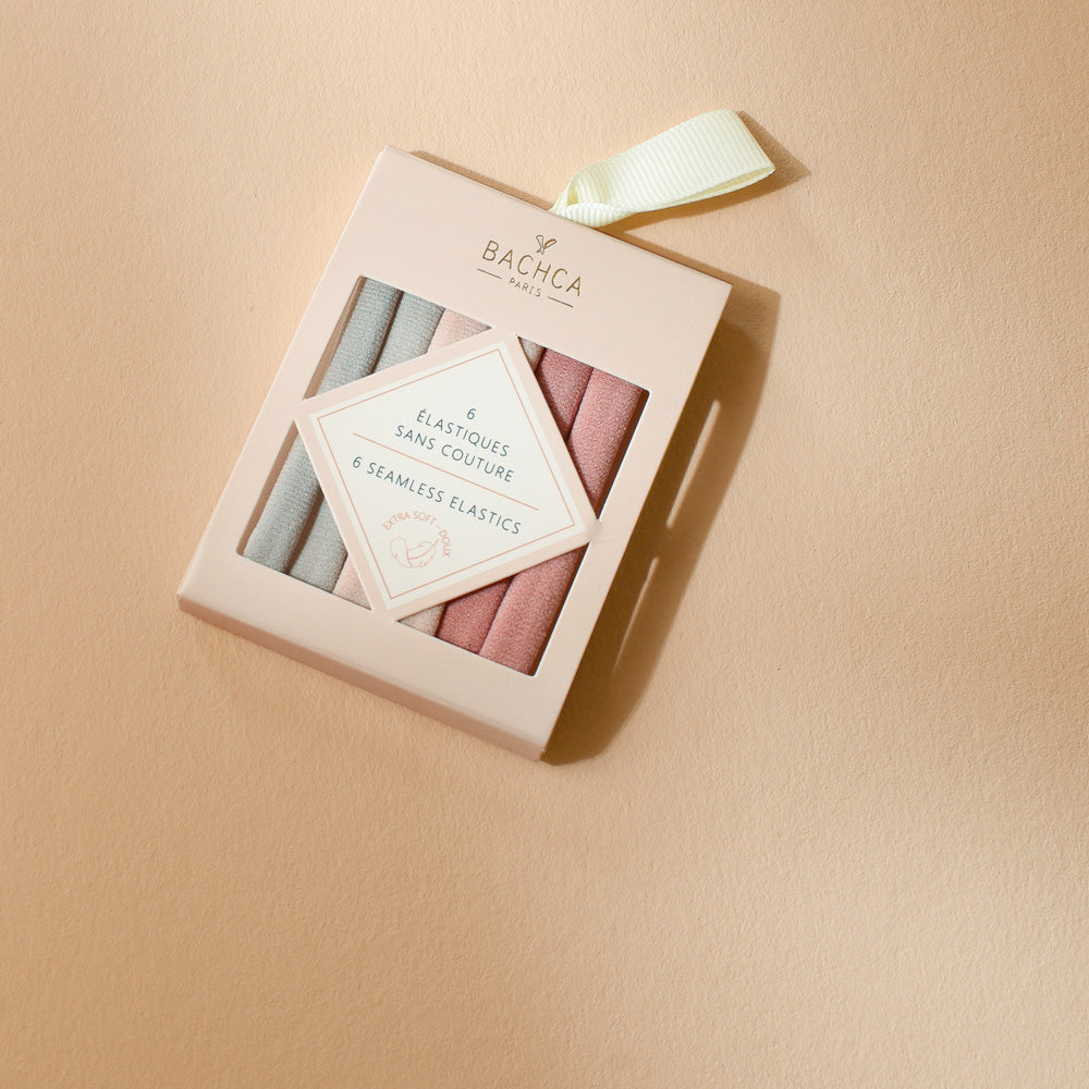 Boîte de 6 élastiques sans couture Bachca en tons rose poudré et gris, extra doux et confortables pour attacher les cheveux sans les abîmer.