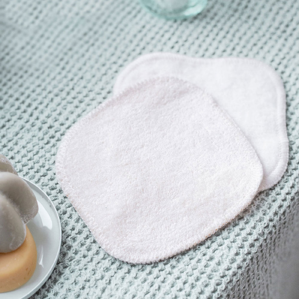 Cotons lavables Bachca posés sur une serviette texturée, prêts à l’usage dans une routine beauté zéro déchet.