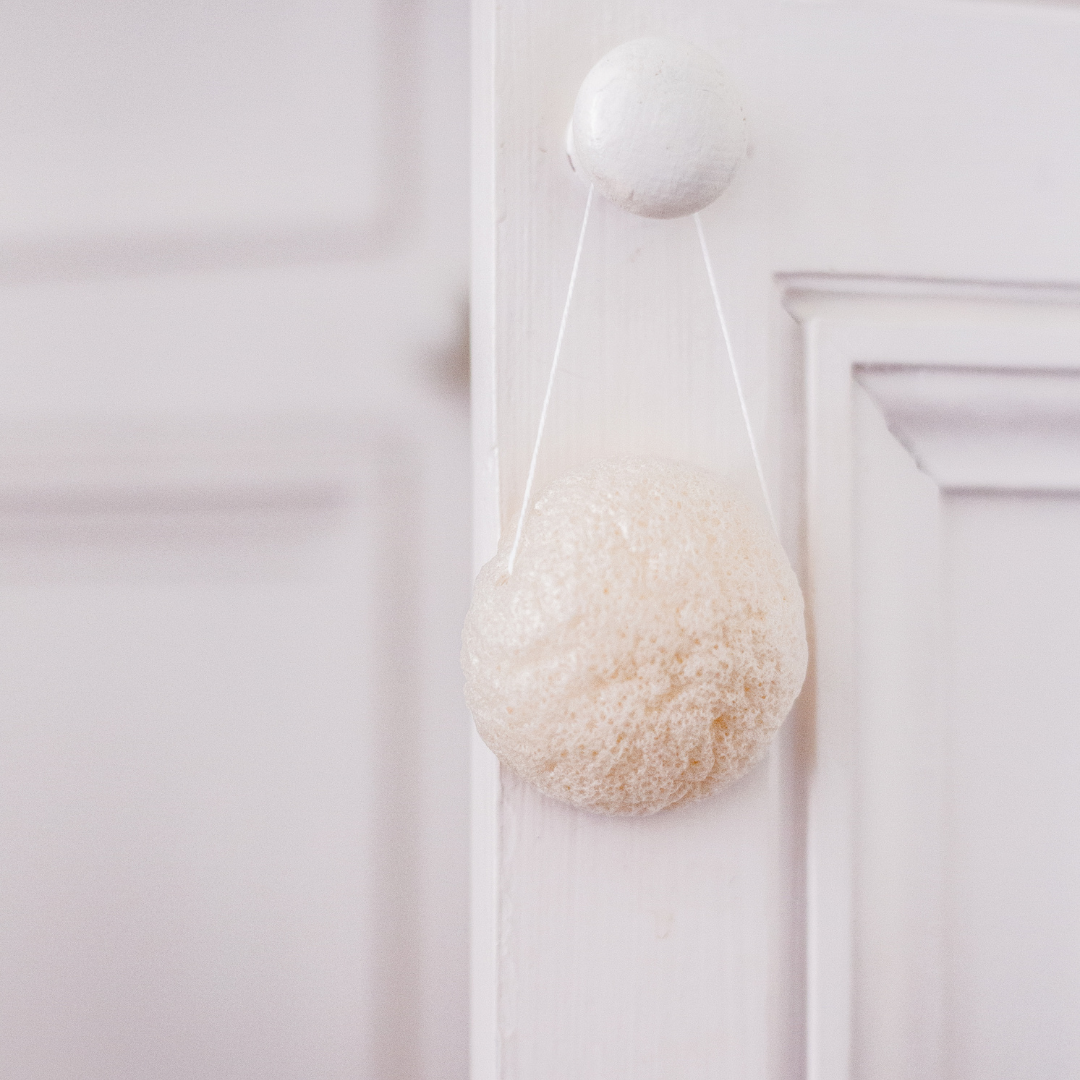 Éponge konjac naturelle Bachca suspendue à une poignée, accessoire de soin du visage nettoyant et doux pour la peau.