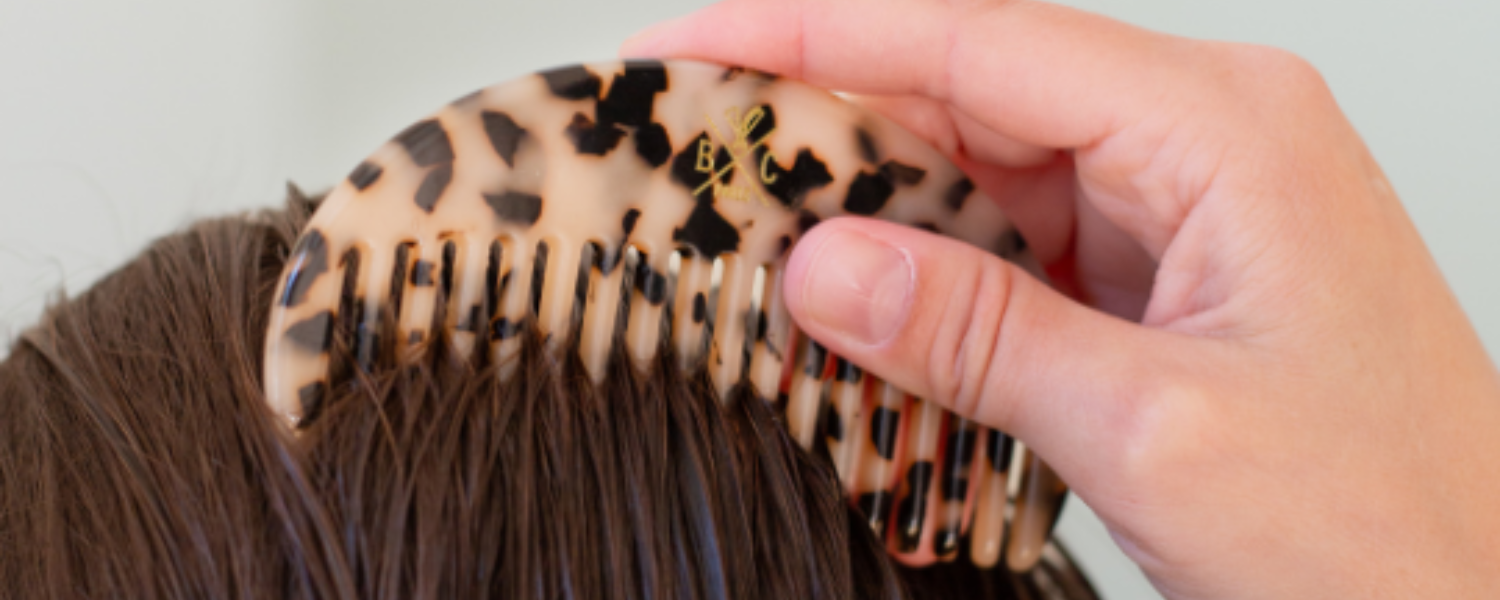 Zoom sur le peigne écaille de la marque Bachca, il est utilisé sur le haut d'une tête aux cheveux mouillés.